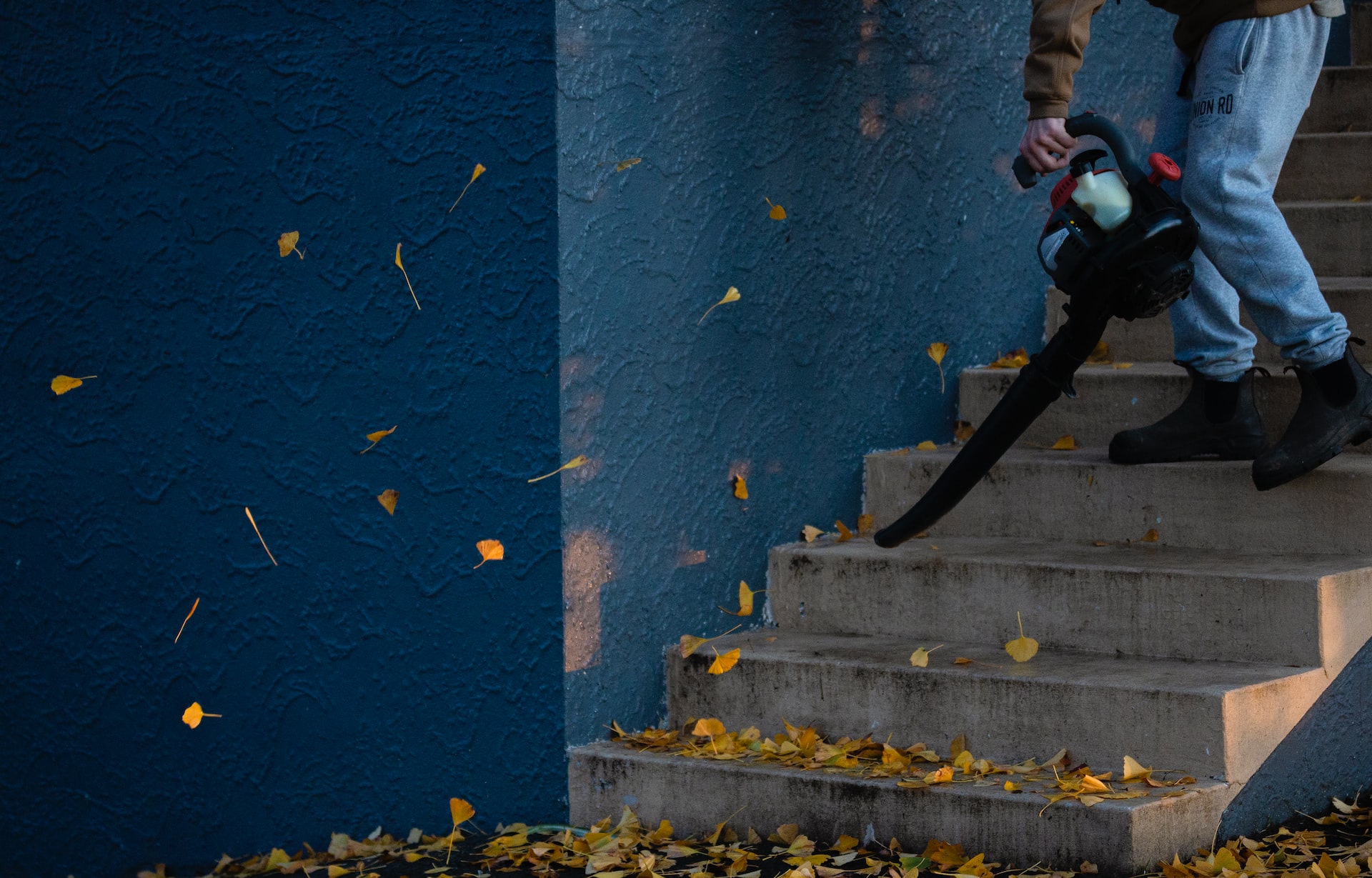 man in black jacket and pants standing on stairs